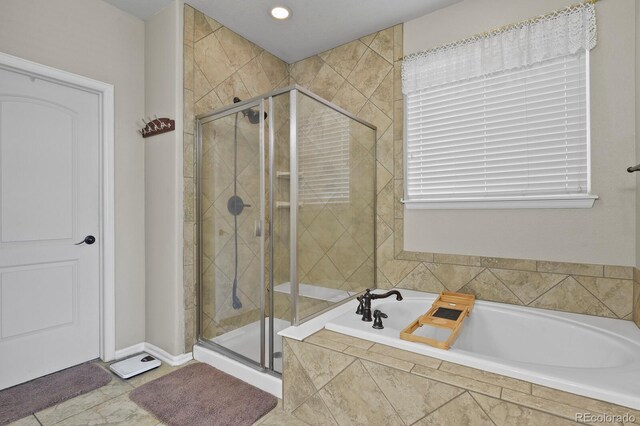 full bathroom with a shower stall and a garden tub