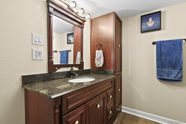 bathroom featuring baseboards and vanity