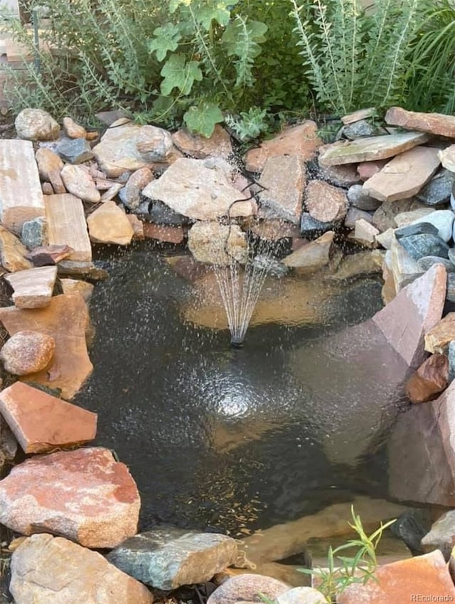 exterior details featuring a small pond