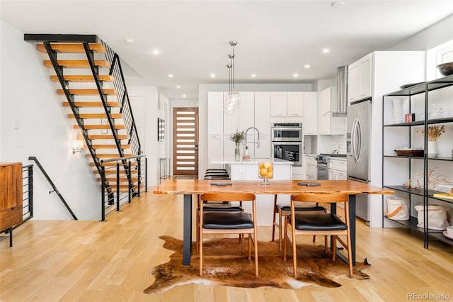 3957 Utica St, Denver, CO 80212 - kitchen with appliances with stainless steel finishes, light wood-style floors, white cabinets, light countertops, and recessed lighting