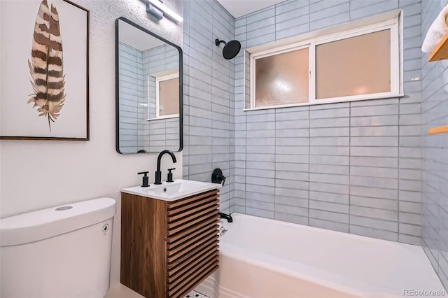 bathroom with toilet, tub / shower combination, and vanity