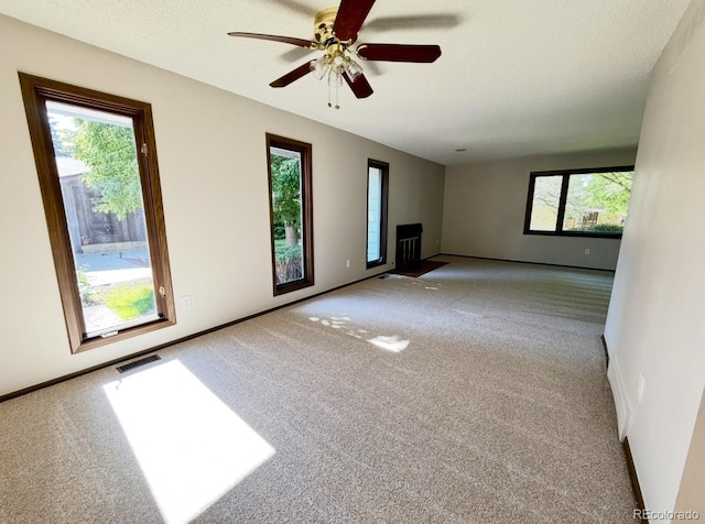 53 Douglas Dr S, Broomfield, CO 80020 - unfurnished living room with carpet, plenty of natural light, and ceiling fan