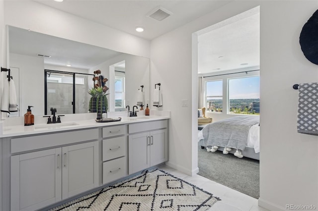 13326 Blue Amber Ct, Parker, CO 80134 - ensuite bathroom featuring double vanity, healthy amount of natural light, a stall shower, tile patterned flooring, and recessed lighting