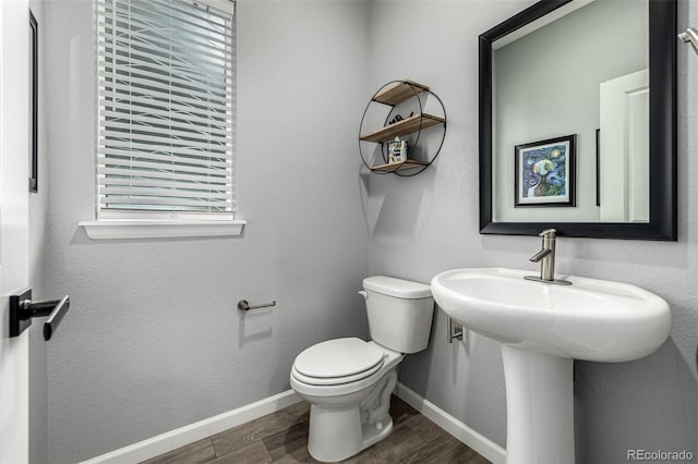 9406 Bross St, Arvada, CO 80007 - bathroom with toilet and wood finished floors