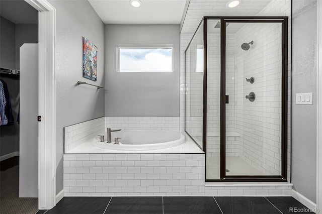 9406 Bross St, Arvada, CO 80007 - bathroom with a stall shower, a garden tub, tile patterned floors, recessed lighting, and a spacious closet