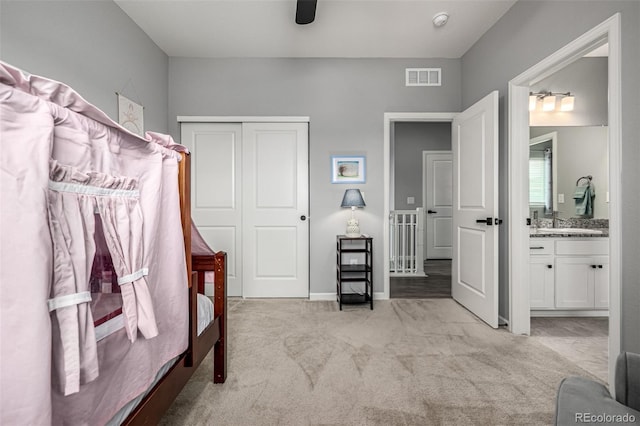 9406 Bross St, Arvada, CO 80007 - bedroom with light colored carpet, a closet, connected bathroom, and a ceiling fan