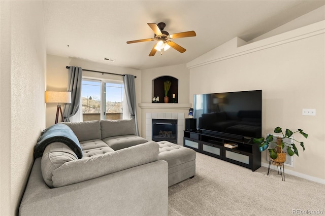 1431 Madison Ridge Hts Unit D, Colorado Springs, CO 80904 - living area featuring vaulted ceiling, a ceiling fan, baseboards, a tiled fireplace, and carpet