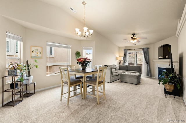 1431 Madison Ridge Hts Unit D, Colorado Springs, CO 80904 - dining space featuring carpet, a fireplace, ceiling fan, a chandelier, and vaulted ceiling