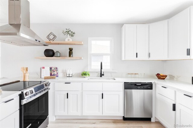 1405 Eaton St, Lakewood, CO 80214 - kitchen with stainless steel appliances, ventilation hood, a sink, white cabinetry, and light countertops