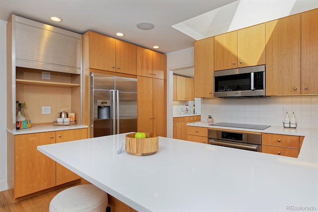 2500 Locust St, Denver, CO 80207 - kitchen with stainless steel appliances, light wood finished floors, light countertops, and recessed lighting