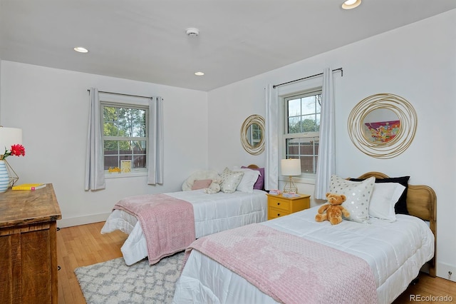 2500 Locust St, Denver, CO 80207 - bedroom with multiple windows, wood finished floors, recessed lighting, and baseboards