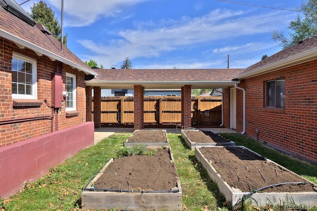 2500 Locust St, Denver, CO 80207 - view of yard featuring a vegetable garden and fence