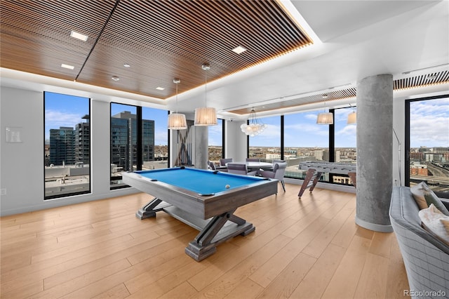 1750 Wewatta St Unit 1301, Denver, CO 80202 - game room featuring a tray ceiling, billiards table, a city view, light wood-style floors, and floor to ceiling windows