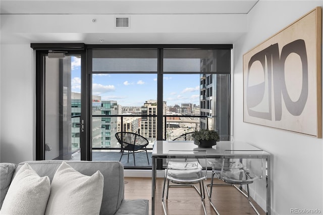 1750 Wewatta St Unit 1301, Denver, CO 80202 - dining space featuring plenty of natural light, wood finished floors, and a view of city