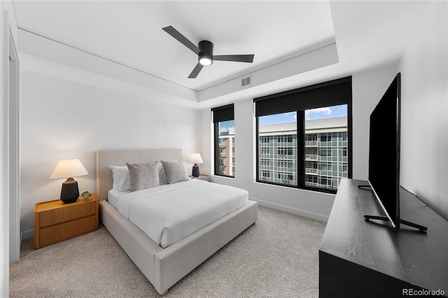 1750 Wewatta St Unit 1301, Denver, CO 80202 - bedroom with a tray ceiling, light carpet, baseboards, and ceiling fan