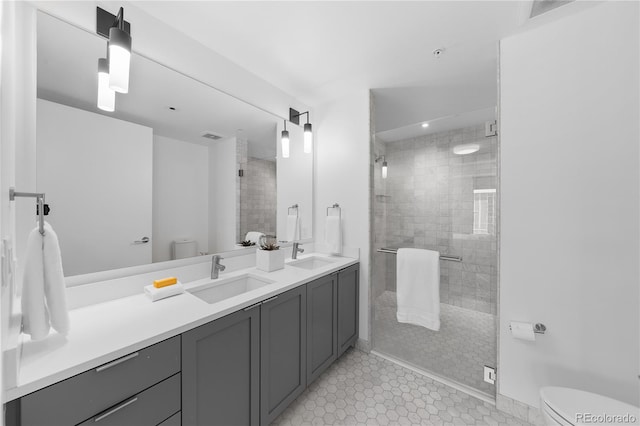 1750 Wewatta St Unit 1301, Denver, CO 80202 - full bathroom featuring toilet, double vanity, a shower stall, and tile patterned floors