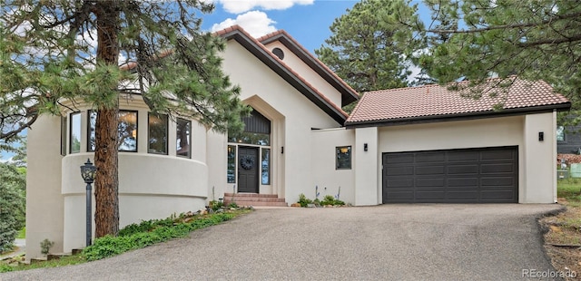 22454 Anasazi Way, Golden, CO 80401 - mediterranean / spanish-style home featuring driveway, stucco siding, a tiled roof, and entry steps