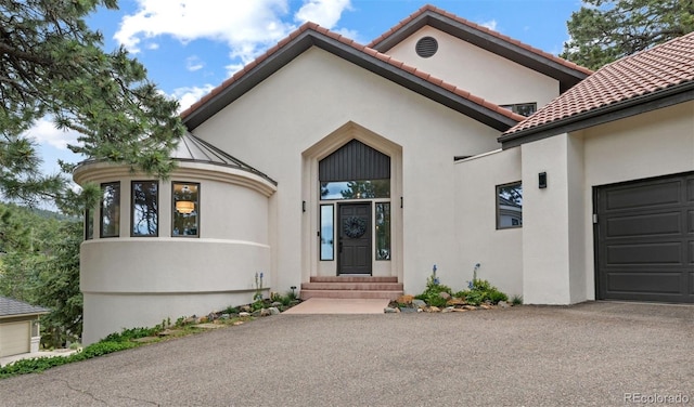 22454 Anasazi Way, Golden, CO 80401 - view of front facade with stucco siding, entry steps, and an attached garage