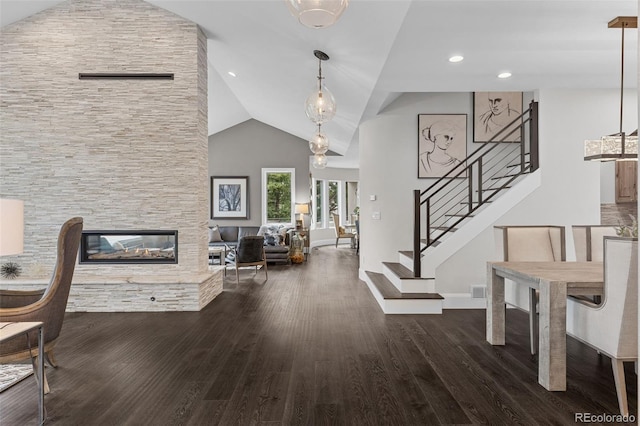 22454 Anasazi Way, Golden, CO 80401 - entryway featuring wood finished floors, stairs, vaulted ceiling, a fireplace, and recessed lighting