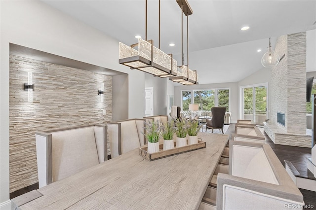 22454 Anasazi Way, Golden, CO 80401 - dining room featuring wood finished floors, recessed lighting, vaulted ceiling, and a fireplace