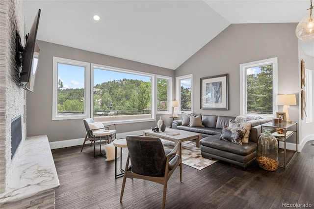 22454 Anasazi Way, Golden, CO 80401 - living area featuring a fireplace, lofted ceiling, dark wood-style flooring, and recessed lighting