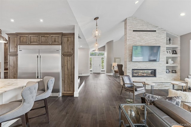 22454 Anasazi Way, Golden, CO 80401 - living area with a fireplace, vaulted ceiling, dark wood-style flooring, recessed lighting, and built in features