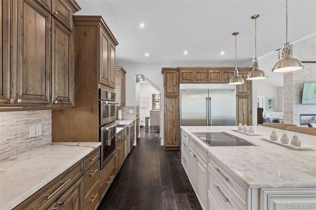 22454 Anasazi Way, Golden, CO 80401 - kitchen with stainless steel appliances, decorative backsplash, dark wood finished floors, light stone counters, and recessed lighting