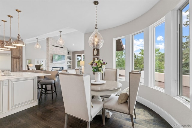 22454 Anasazi Way, Golden, CO 80401 - dining space with healthy amount of natural light, vaulted ceiling, dark wood-type flooring, and a large fireplace