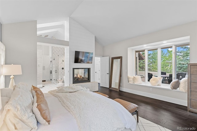 22454 Anasazi Way, Golden, CO 80401 - bedroom with wood finished floors, high vaulted ceiling, and a multi sided fireplace
