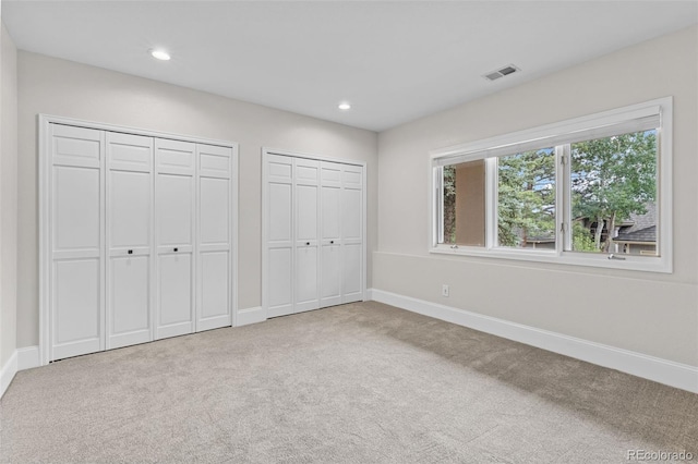 22454 Anasazi Way, Golden, CO 80401 - unfurnished bedroom with two closets, carpet, and recessed lighting