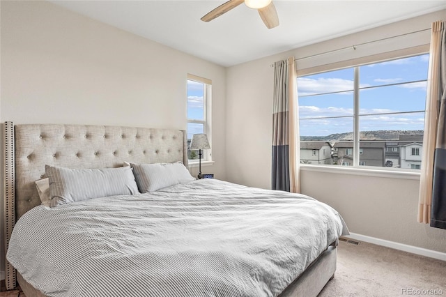 bedroom featuring multiple windows, carpet floors, and ceiling fan