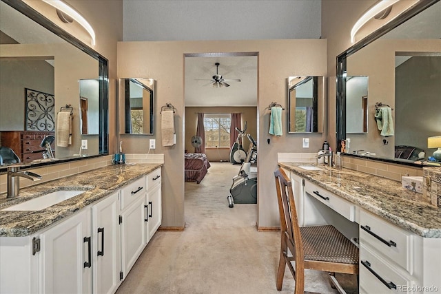 full bathroom with a ceiling fan, a sink, two vanities, and ensuite bathroom