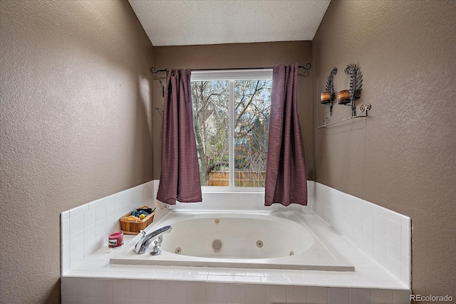 bathroom featuring a whirlpool tub and a textured wall