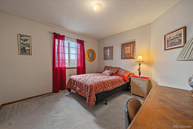 bedroom featuring baseboards, carpet, a textured ceiling, and visible vents