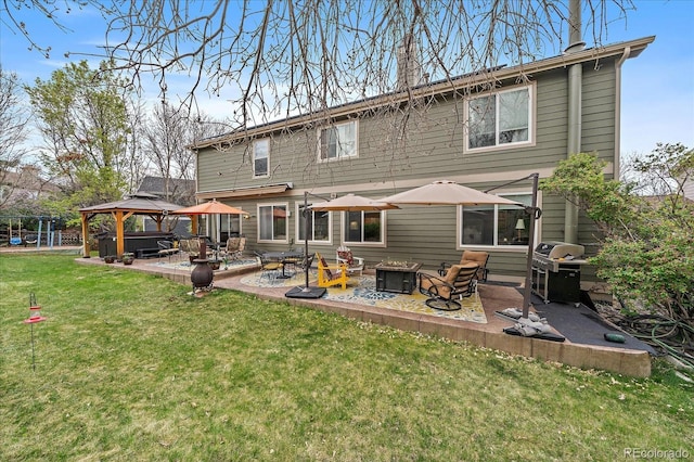 back of house with a gazebo, a patio area, a lawn, and a fire pit