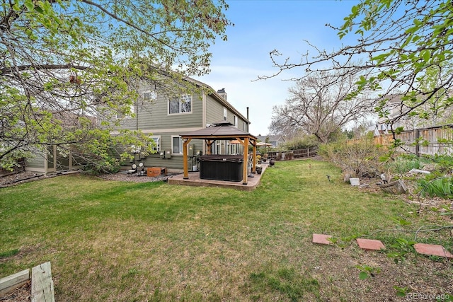 view of yard featuring a fenced backyard, a gazebo, a hot tub, and a patio area