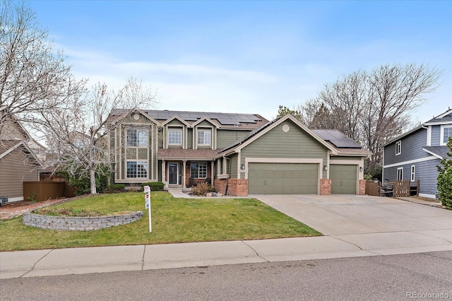 view of front of house with fence, roof mounted solar panels, a front yard, and a garage