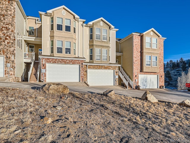 view of property with a garage and a balcony