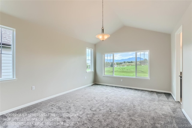 carpeted empty room featuring vaulted ceiling and baseboards