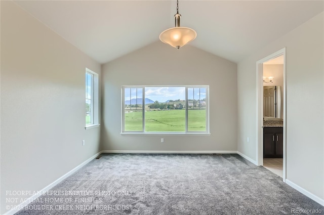 interior space featuring baseboards, vaulted ceiling, and light colored carpet