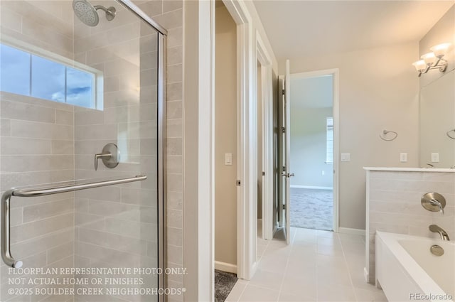 full bathroom with a shower stall, baseboards, a bath, and tile patterned floors