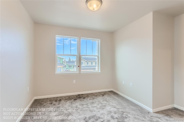 unfurnished room featuring carpet and baseboards