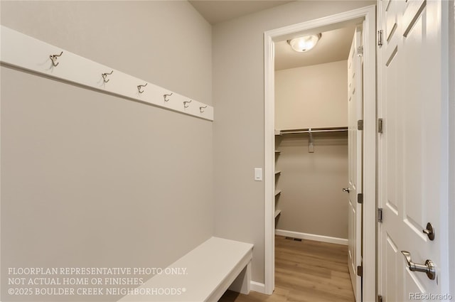 mudroom with wood finished floors and baseboards