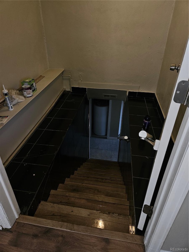 stairway featuring hardwood / wood-style floors