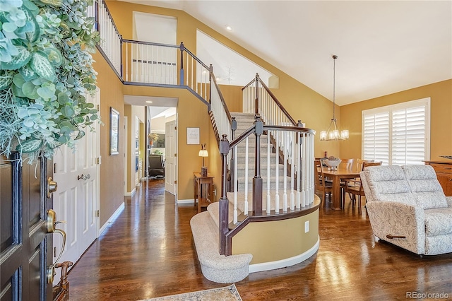 31170 Cinnamonwood, Evergreen, CO 80439 - foyer entrance featuring baseboards, an inviting chandelier, stairs, dark wood-type flooring, and high vaulted ceiling