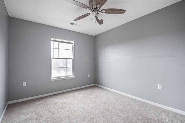 unfurnished room with a ceiling fan, carpet flooring, and baseboards