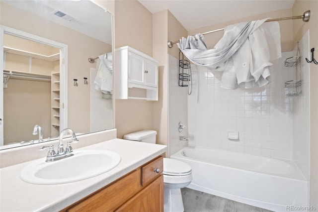 1473 Red Cliff Way, Castle Rock, CO 80109 - bathroom featuring toilet, shower / washtub combination, vanity, wood finished floors, and a spacious closet