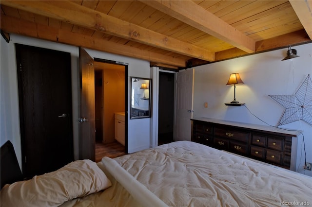 bedroom with ensuite bathroom, wood ceiling, and beamed ceiling