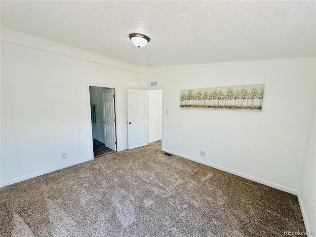 unfurnished bedroom with a textured ceiling, a closet, and carpet flooring