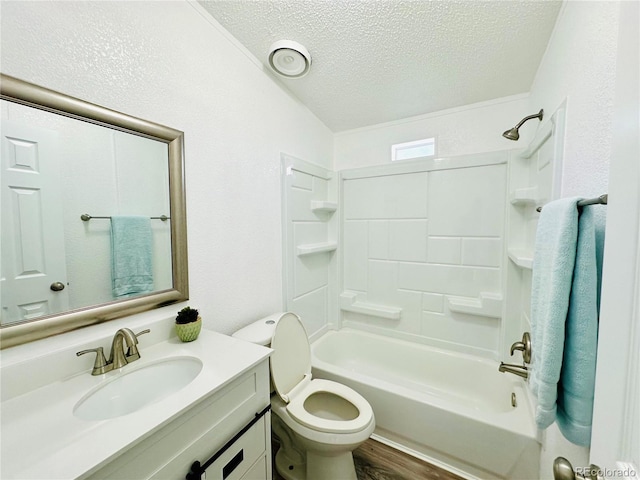 full bathroom featuring vanity, a textured ceiling, washtub / shower combination, hardwood / wood-style flooring, and toilet